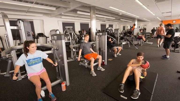 Students use exercise machines in the Gold Student Center gym